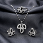 Silver leaf stone jewelry set by Zaraya Store with black marquise-cut and clear pavé stones, including necklace, ring, and earrings on dark fabric.