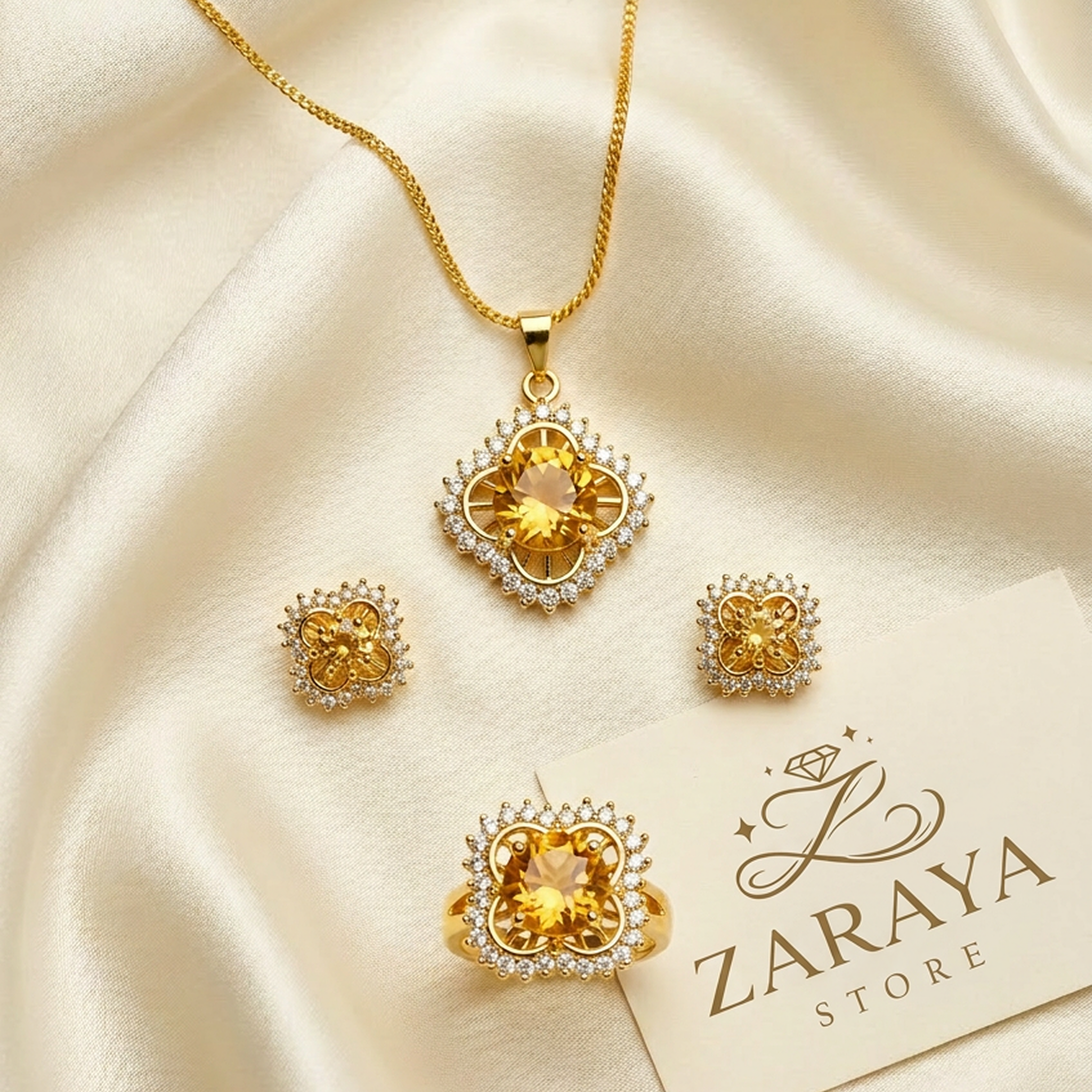 Golden yellow and gold jewelry set by Zaraya Store, featuring clover-shaped designs with round stones and white accents.