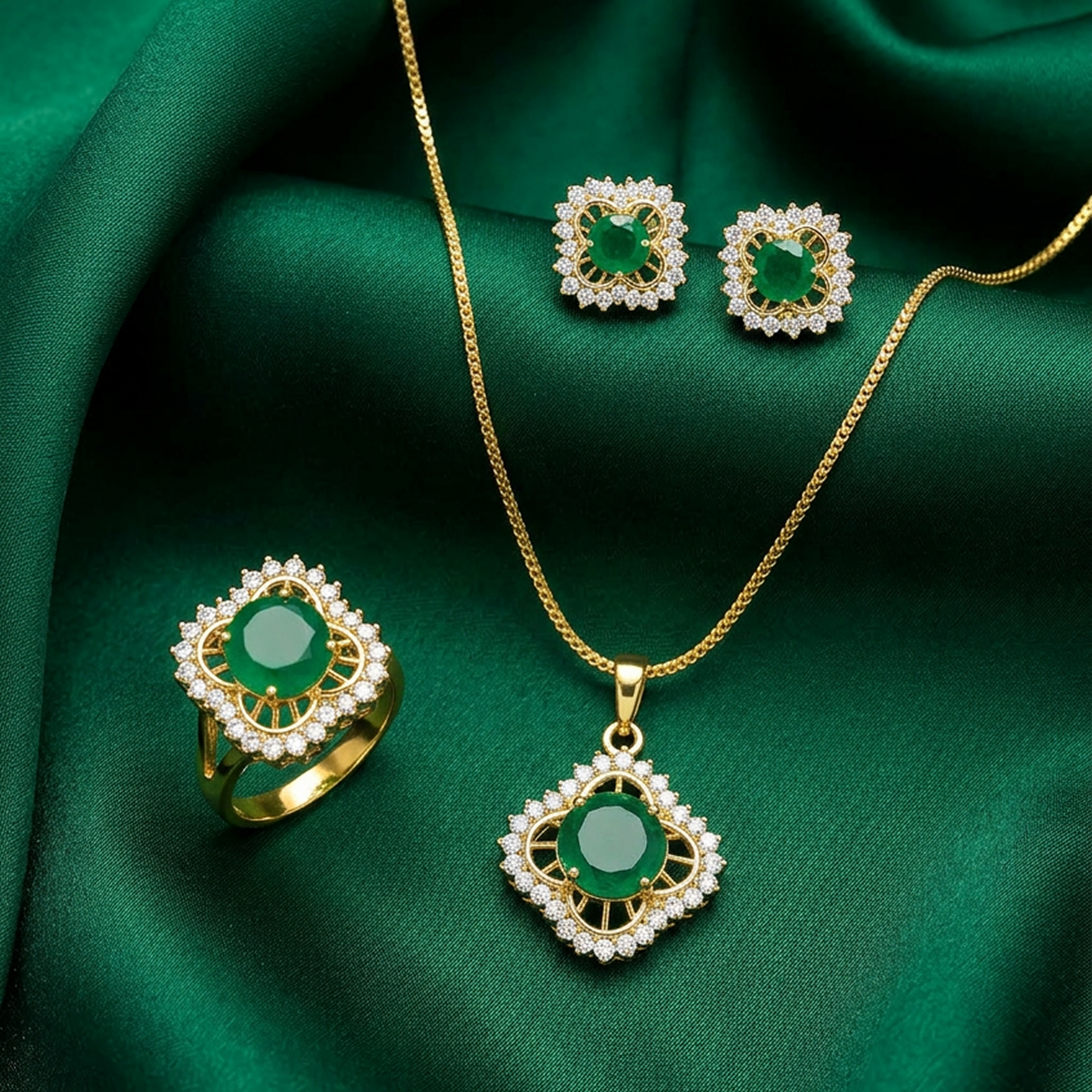 Green round stone gold jewelry set featuring a ring, stud earrings, and necklace with pendant, displayed on dark green fabric.