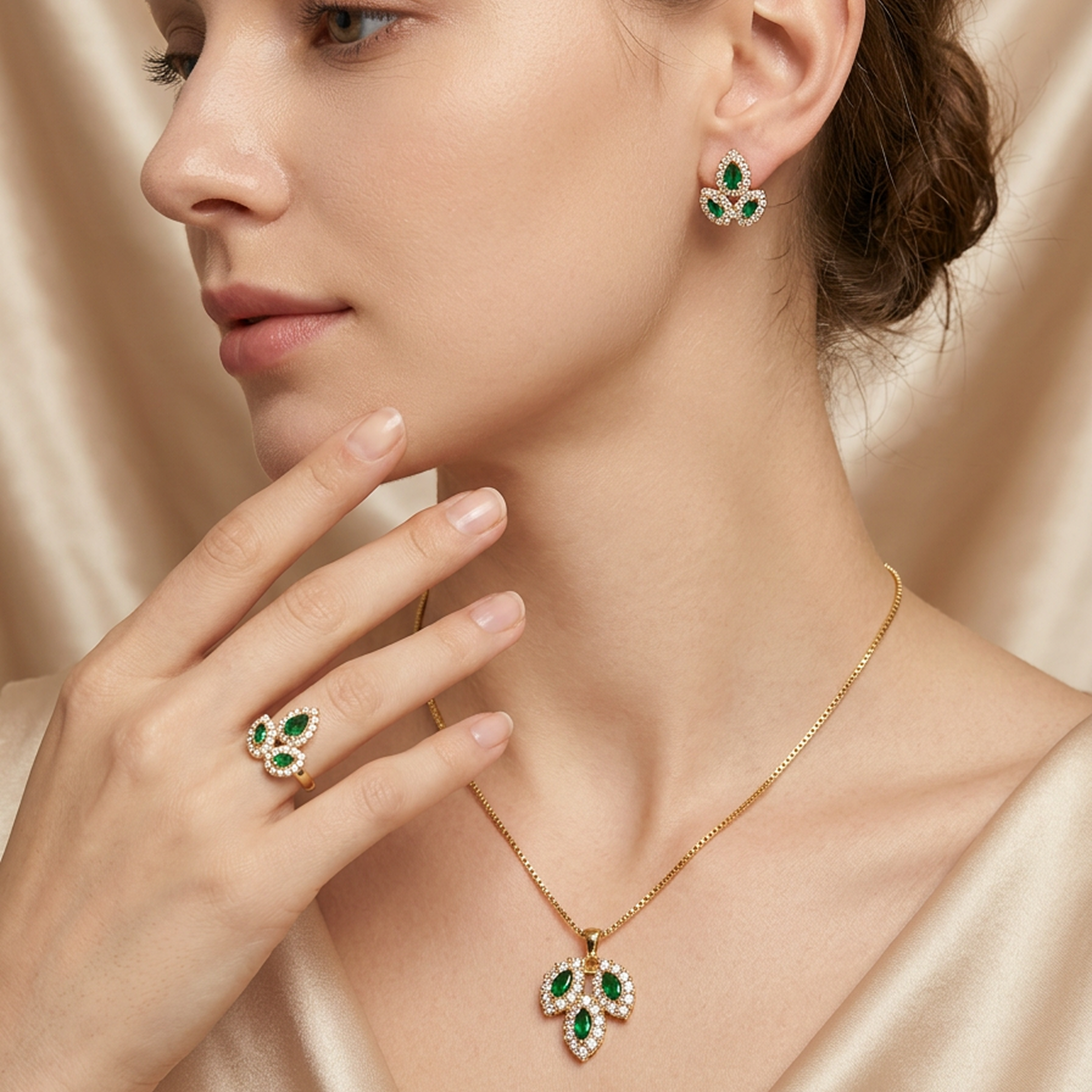 Gold leaf jewelry set by Zaraya Store, featuring green and white stones on a model.