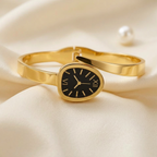 Gold stainless steel snake wrap bracelet watch by Zaraya Store, with black dial and Roman numerals, on beige satin.