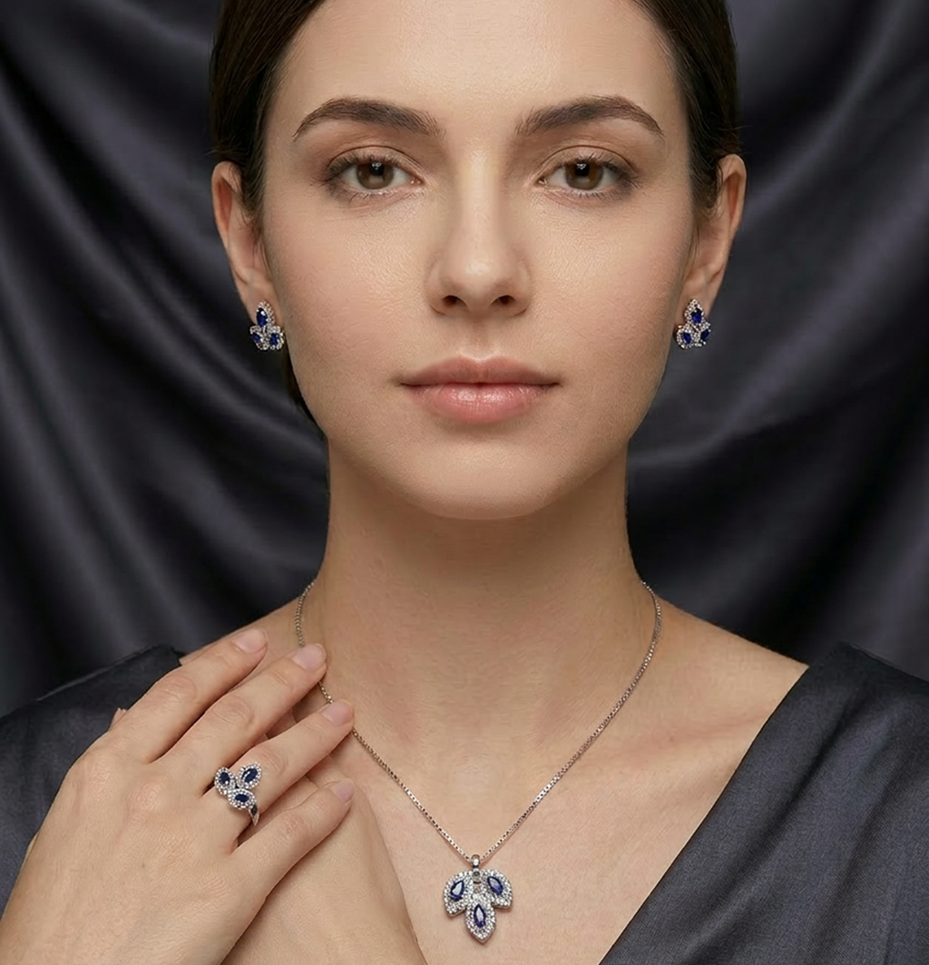 Silver leaf stone jewelry set by Zaraya Store, featuring a necklace, earrings, and ring with blue and clear stones, worn by a woman.