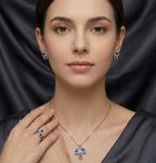 Silver leaf stone jewelry set by Zaraya Store, featuring a necklace, earrings, and ring with blue and clear stones, worn by a woman.