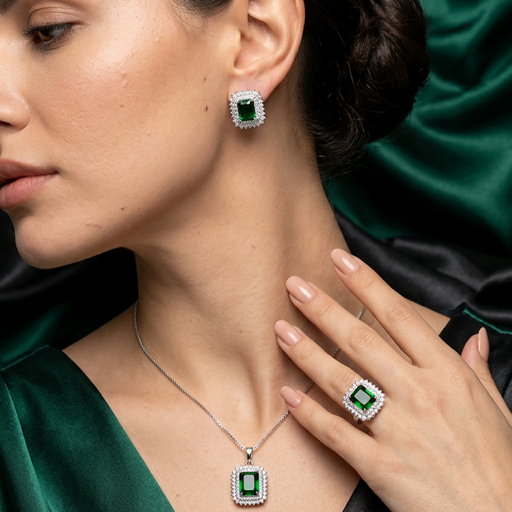 Silver jewelry set with green square stones from Zaraya Store, featuring a necklace, stud earrings, and a ring.