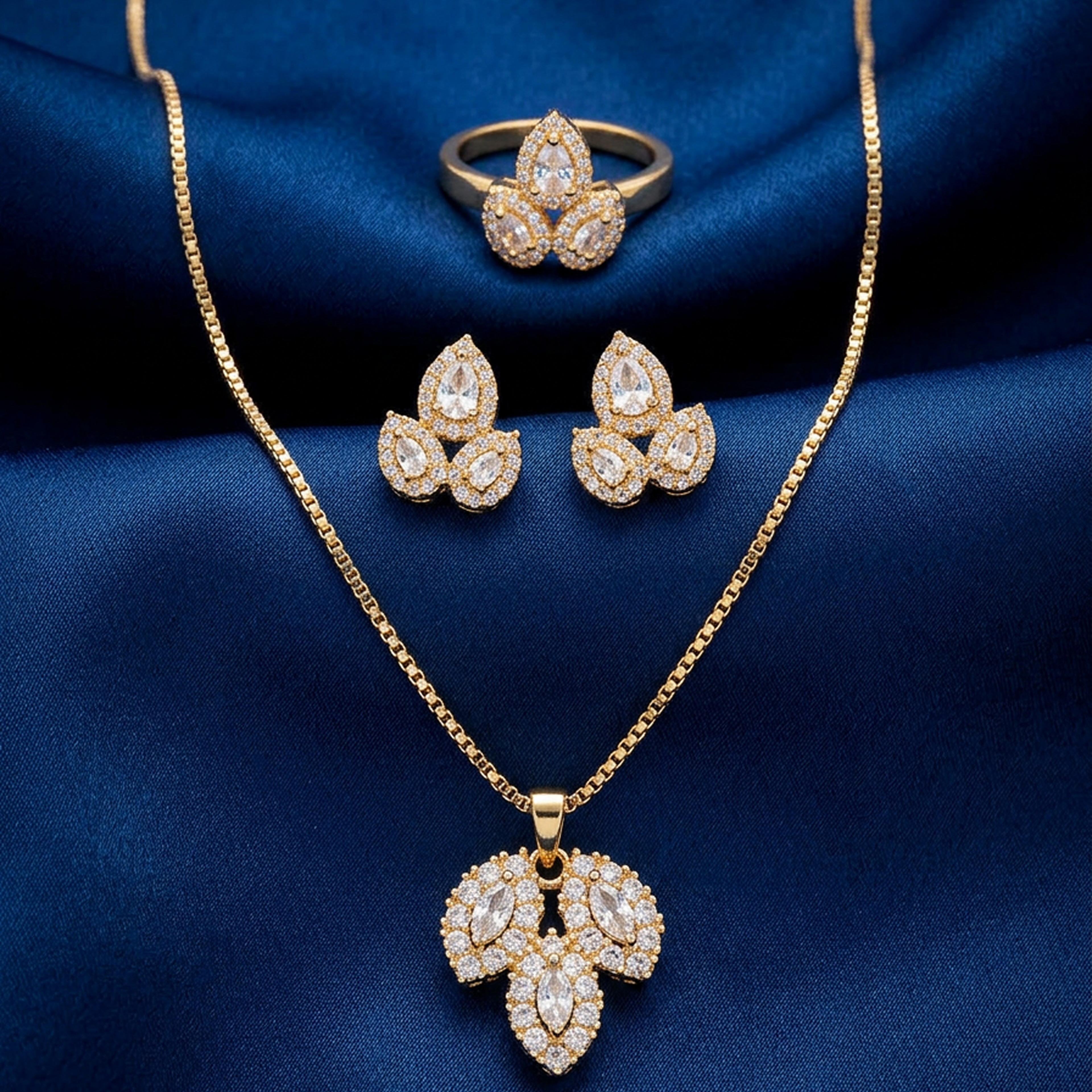 Luxury gold leaf stone jewelry set from Zaraya Store, featuring a necklace, ring, and earrings on blue fabric.